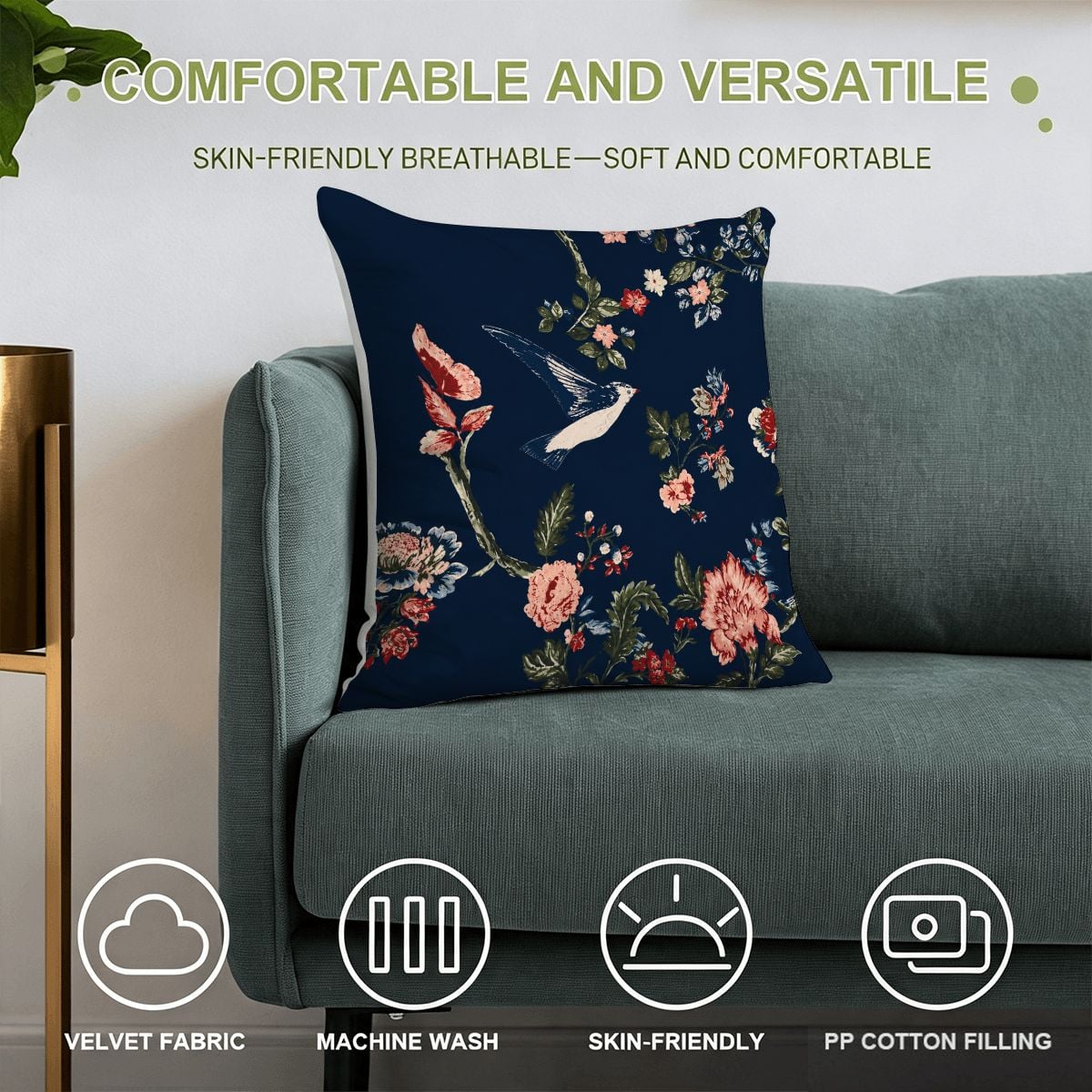 Navy blue floral throw pillow with bird pattern on a teal sofa.
