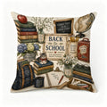 Decorative throw pillow featuring school supplies, books, flowers, and a cute tabby cat.