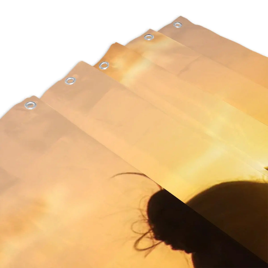 Sandy Beach silhouette heart sunset shower curtain hanging in a bathroom with ocean-themed decor and natural light.