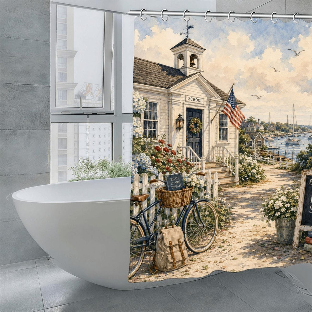 Vintage schoolhouse building with American flag and bicycle in a coastal garden setting.
