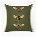 Decorative green throw pillow featuring vintage botanical illustrations of three different bees.