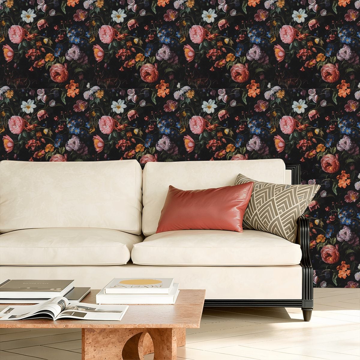 Cream sofa with red and geometric pillows against dark floral wallpaper.