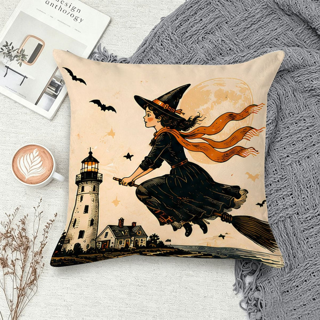 Decorative throw pillow featuring a witch flying on a broomstick past a lighthouse and full moon.