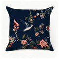 Navy blue decorative throw pillow with vintage floral patterns and a flying bird design.