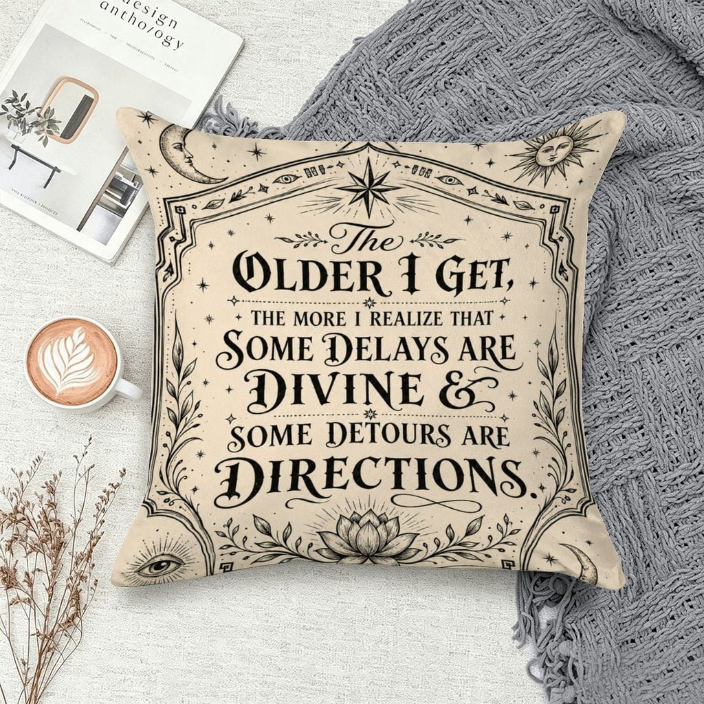 Decorative cream throw pillow with inspirational quote about divine delays and detours.