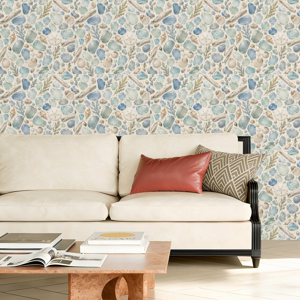 Modern cream sofa with terracotta and geometric pillows against blue seashell pattern wallpaper.