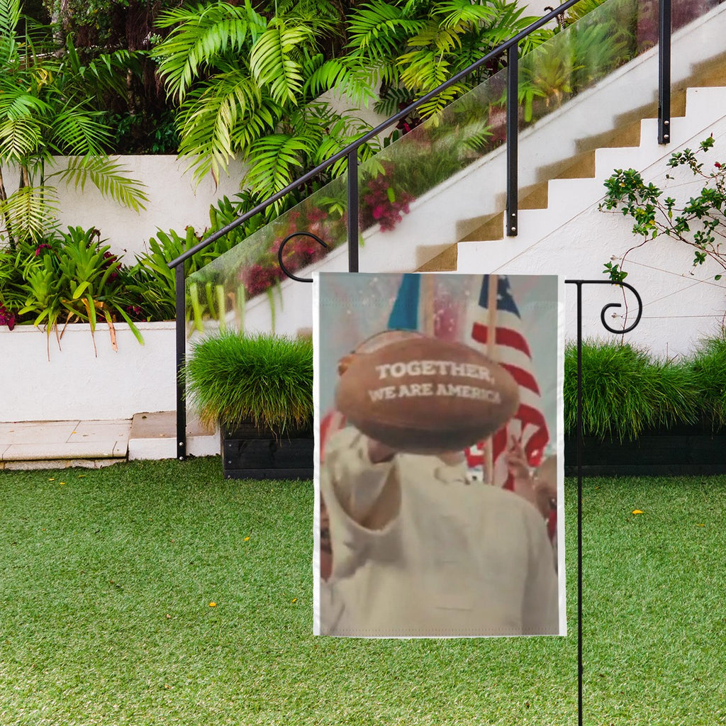 Sandy Beach "Together We Are America" football garden flag hanging outdoors, featuring patriotic design for garden decor.