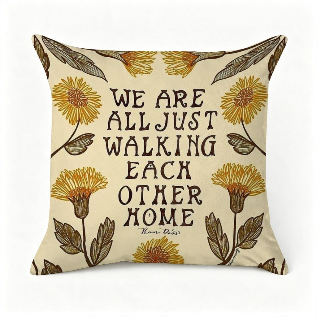 Cream decorative throw pillow with yellow floral patterns and Ram Dass quote.