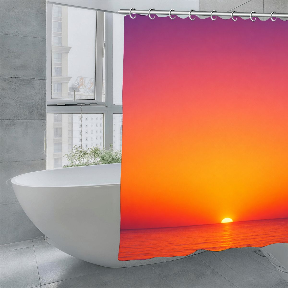 Sunset ocean landscape shower curtain hanging next to a white freestanding bathtub.