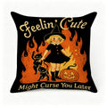 Halloween throw pillow featuring a cute witch, black cats, and a pumpkin on a black background.