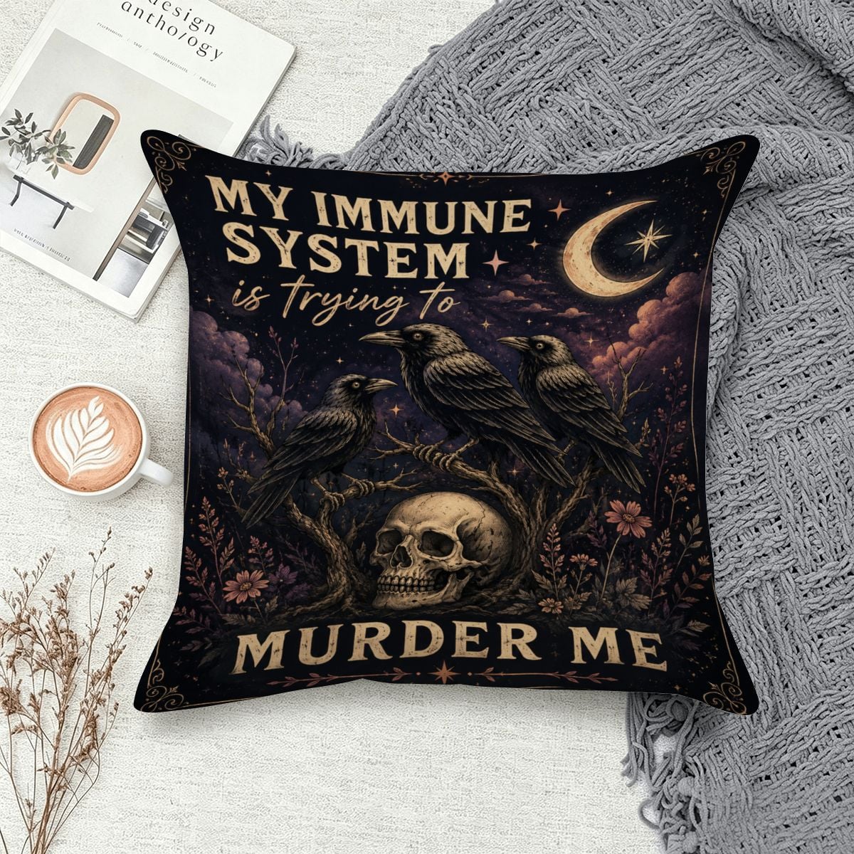 Decorative throw pillow featuring spooky crows, a skull, and moon under text 'My immune system is trying to murder me'.