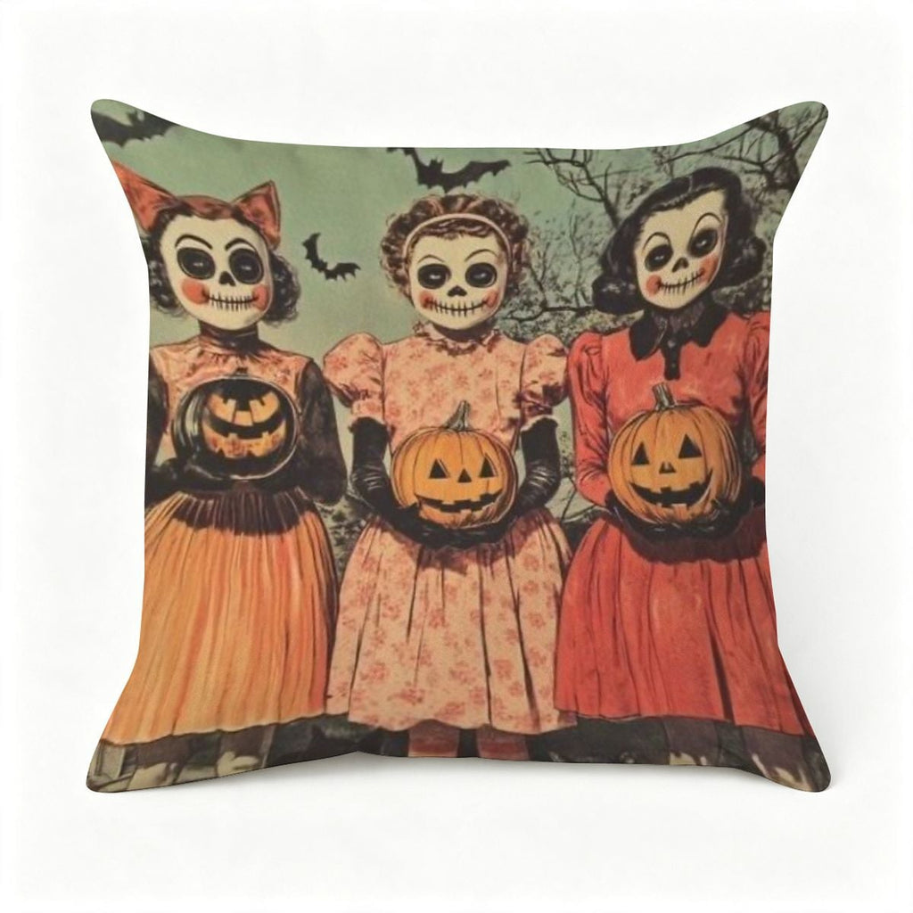 Halloween throw pillow featuring three girls in vintage dresses holding jack-o'-lanterns.
