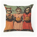 Halloween throw pillow featuring three girls in vintage dresses holding jack-o'-lanterns.