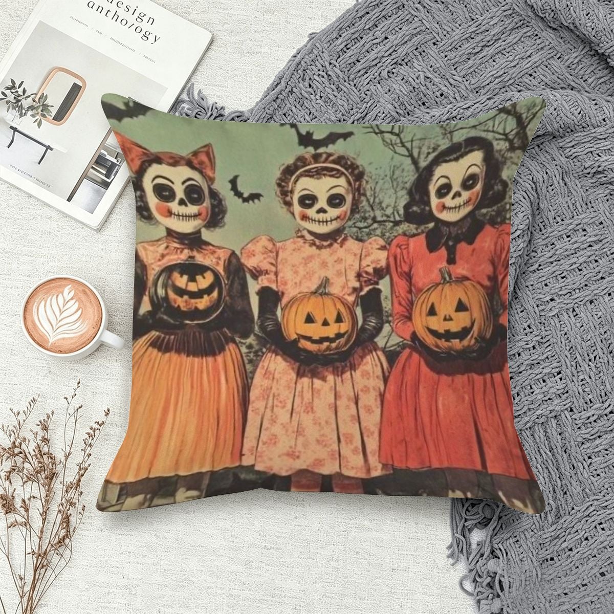 Halloween decorative pillow featuring three vintage-style girls in skeleton face paint holding pumpkins