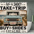 Vintage blue Bronco SUV on a coastal road with Life is Short Take the Trip text shower curtain.