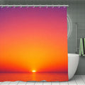 Sunset over the ocean with vibrant orange and pink sky shower curtain in a modern bathroom.