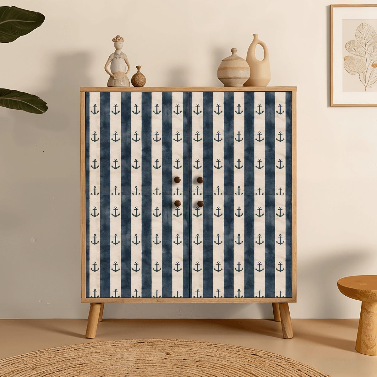 Nautical striped cabinet with anchor pattern and wooden knobs in a minimalist room setting.