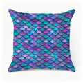 Decorative throw pillow with iridescent purple and teal mermaid scale pattern.