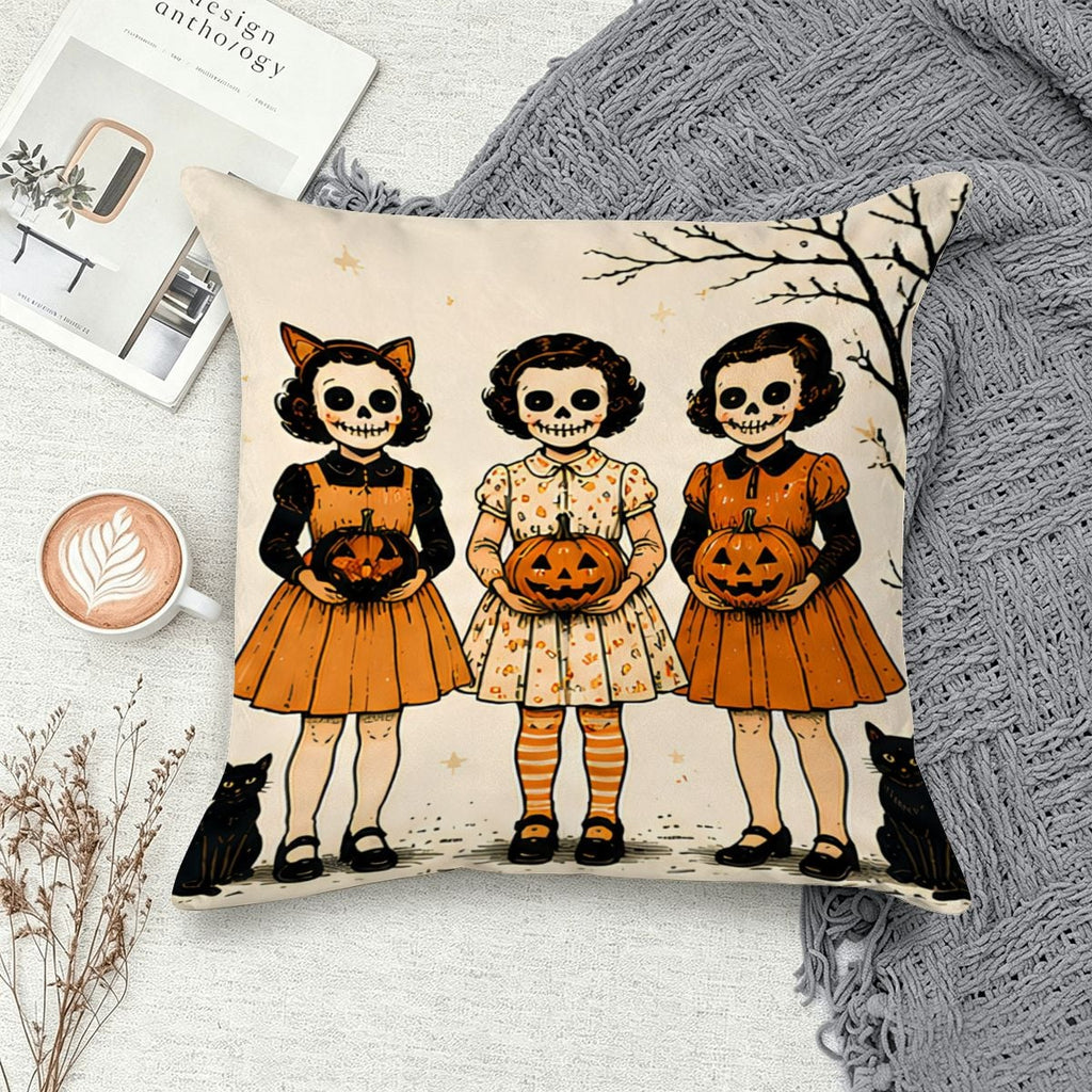 Halloween throw pillow featuring three girls in spooky dresses holding jack-o'-lanterns.