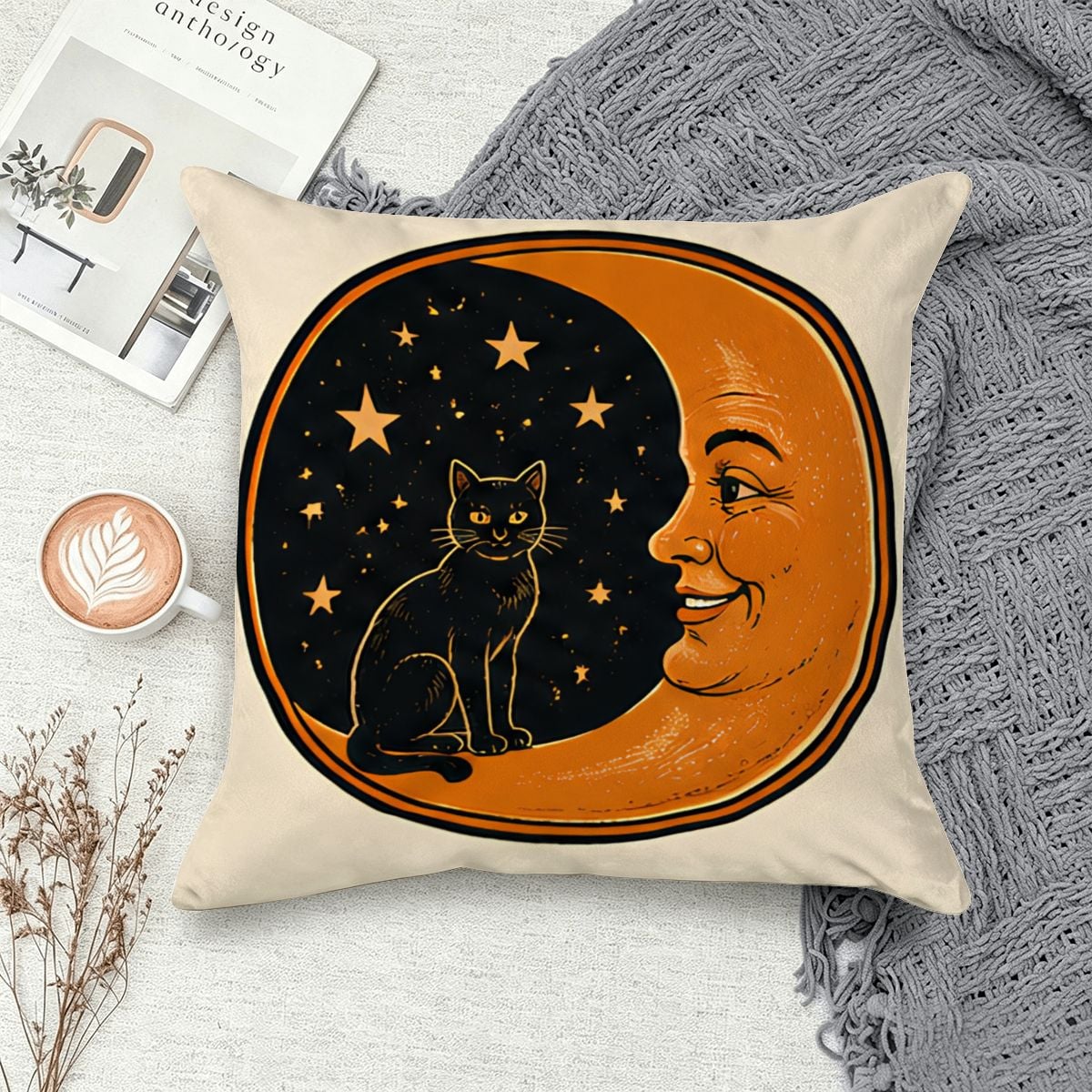 Decorative cream throw pillow featuring a black cat sitting on a crescent moon with a face.