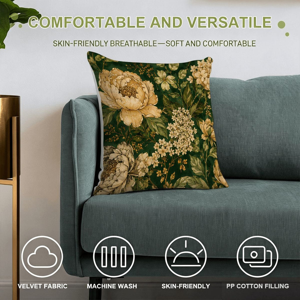 Floral print velvet throw pillow with cream peonies on a dark green background on a blue sofa.