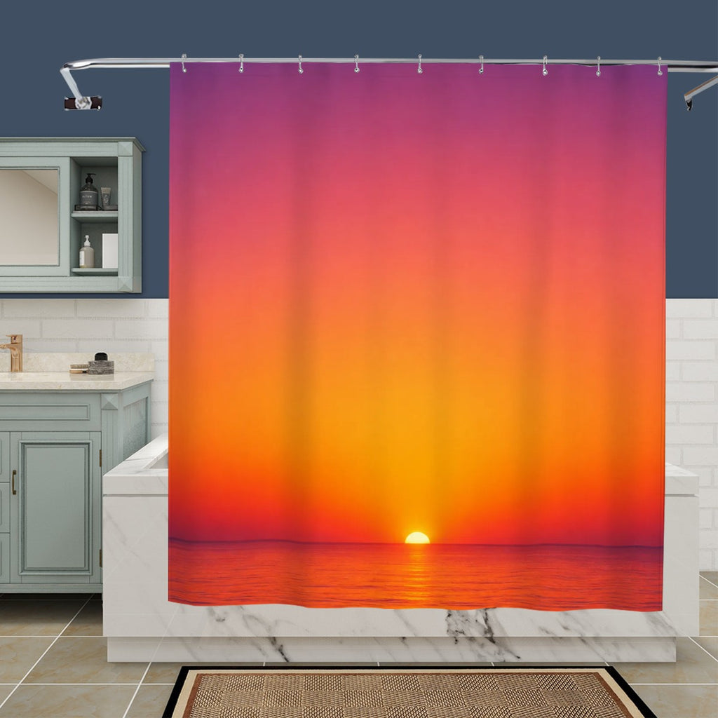 Vibrant sunset over ocean print shower curtain in a modern bathroom setting.