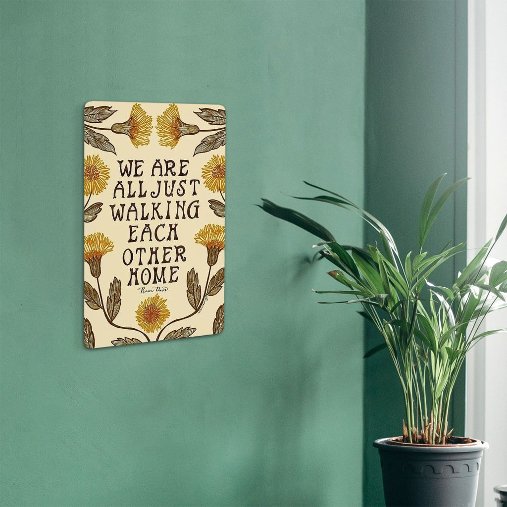 Floral garden flag with inspirational quote We Are All Just Walking Each Other Home.