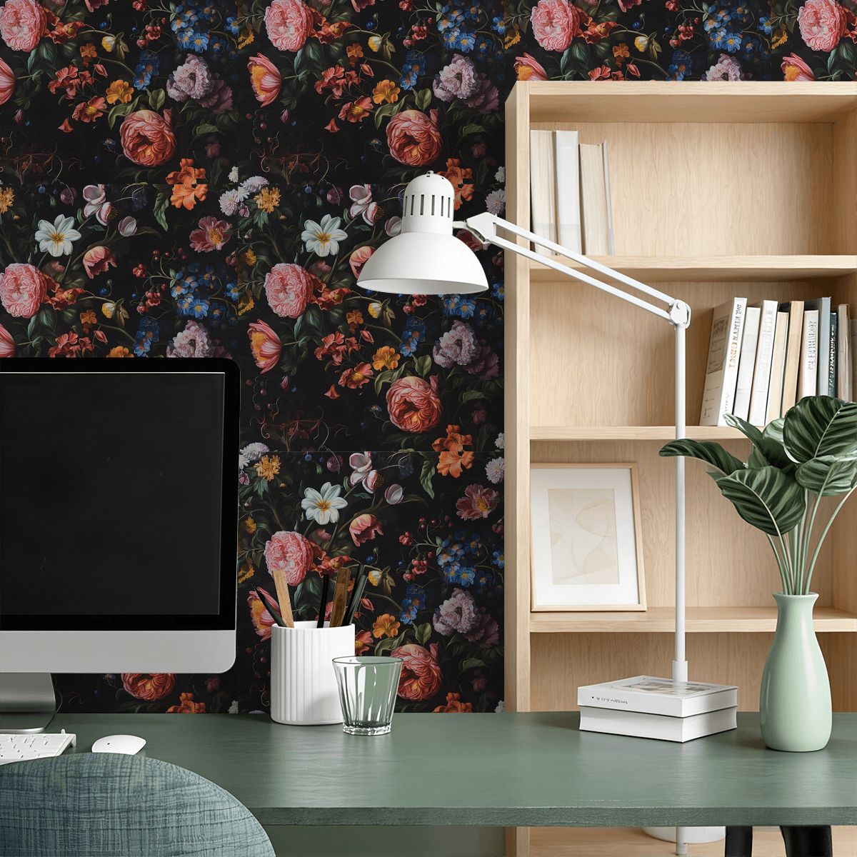 Home office desk with computer, lamp, and dark floral pattern wallpaper.