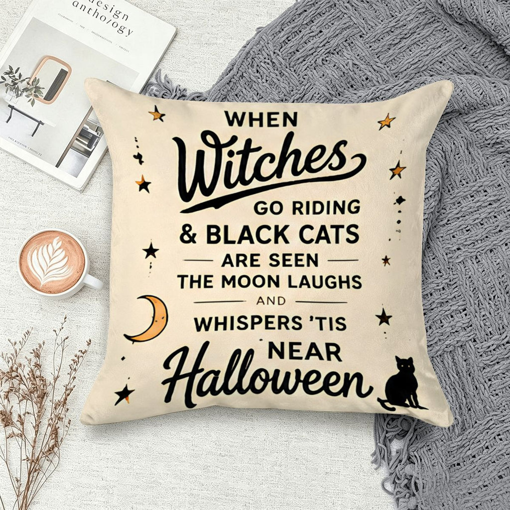 Cream Halloween throw pillow with black witch calligraphy and black cat illustration.