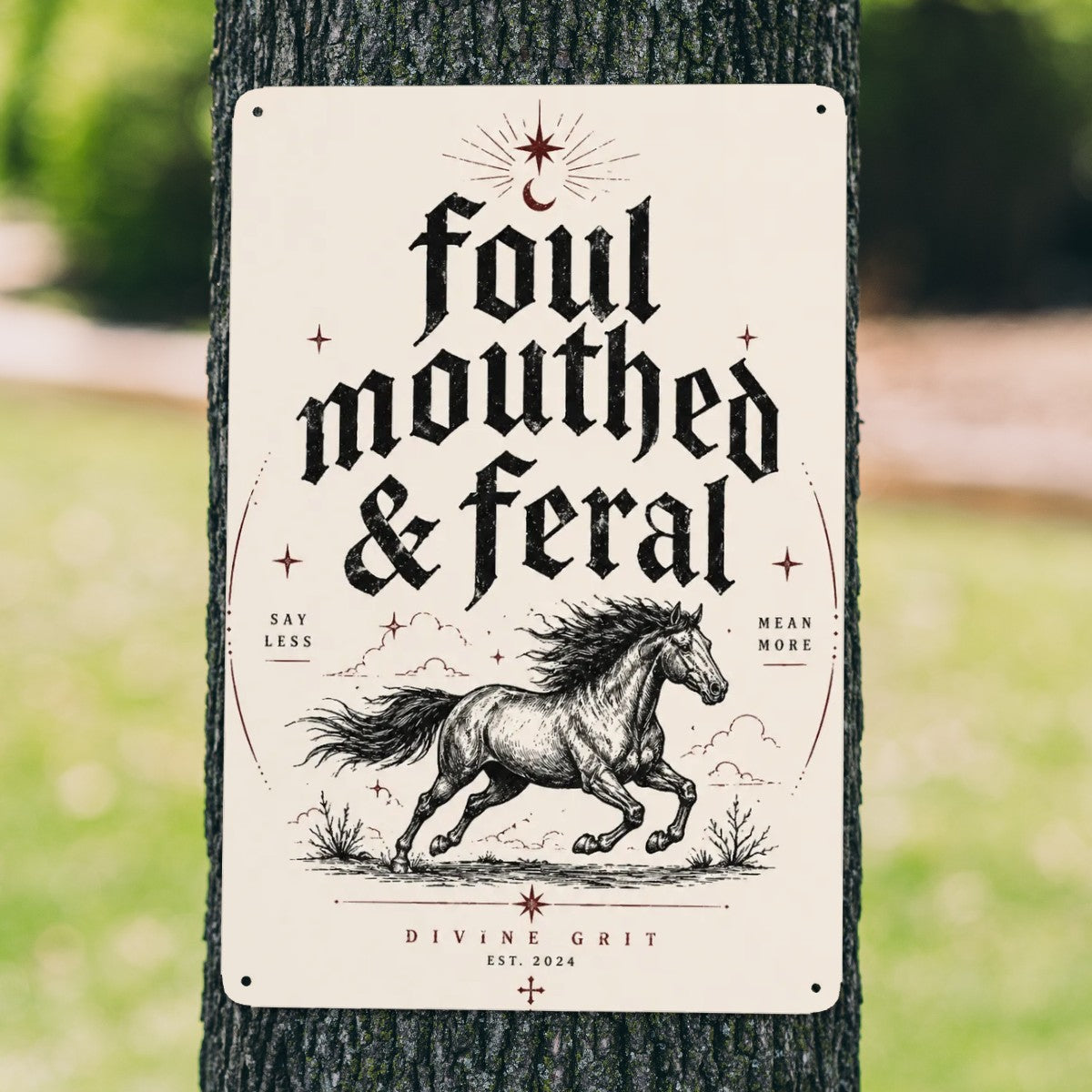 Vintage style garden flag with running horse and text 'foul mouthed & feral' on a tree.