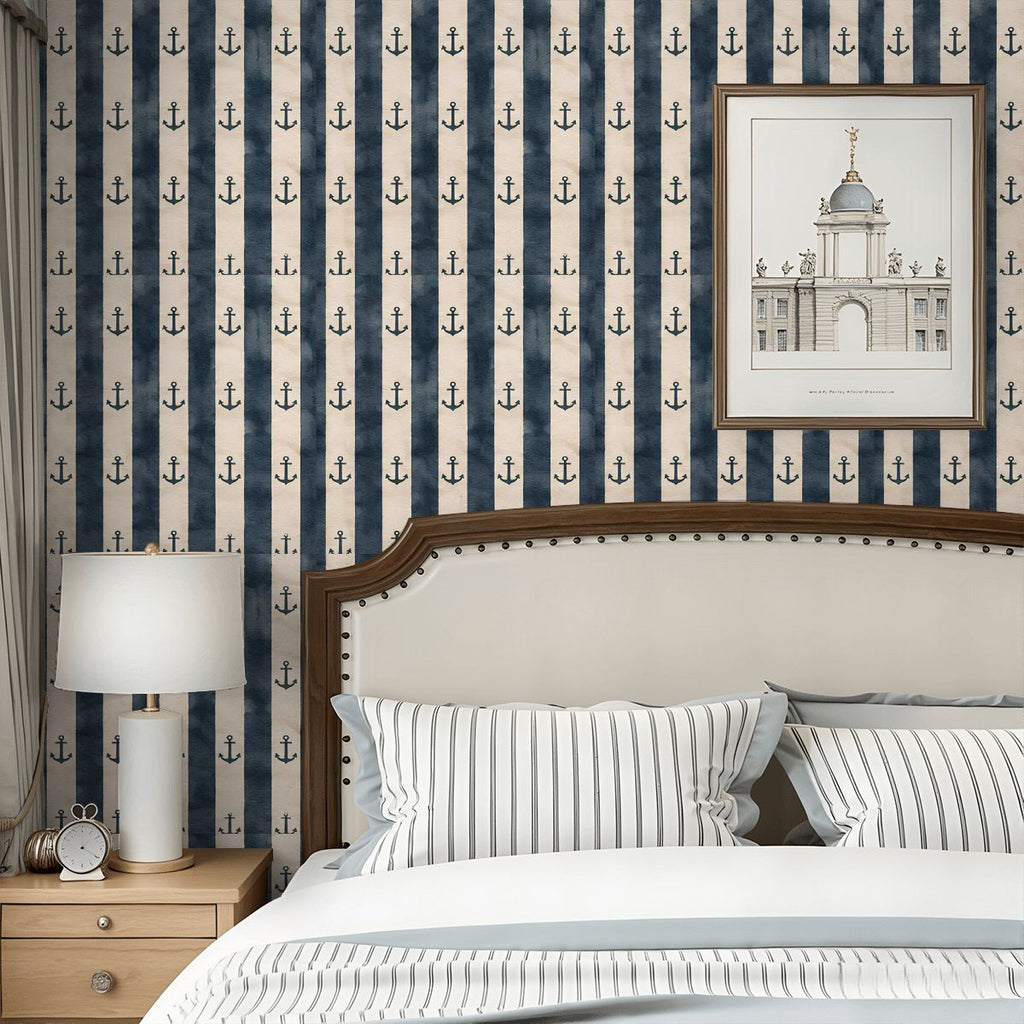 Nautical navy blue and white striped wallpaper with anchor pattern in a bedroom setting.