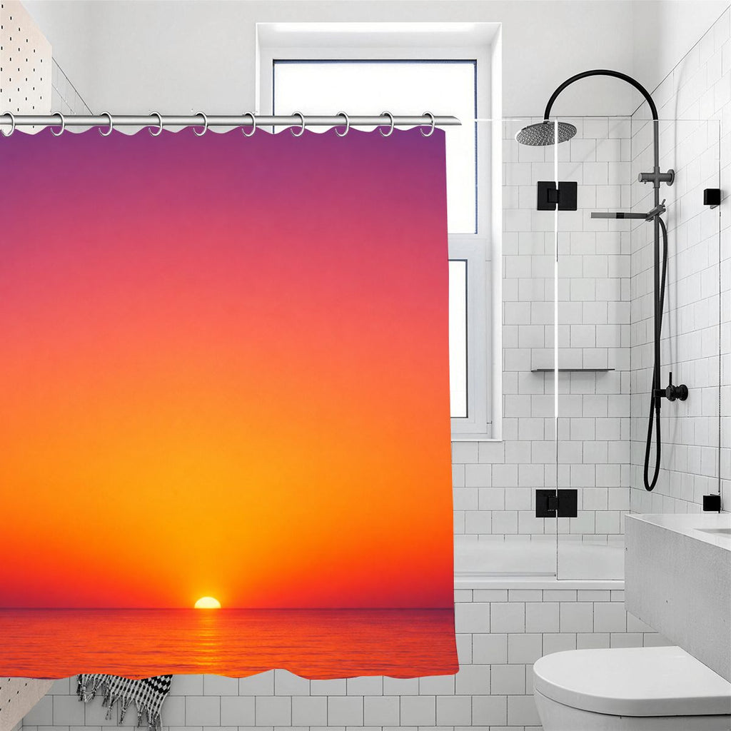 Sunset ocean landscape shower curtain in a white tiled bathroom