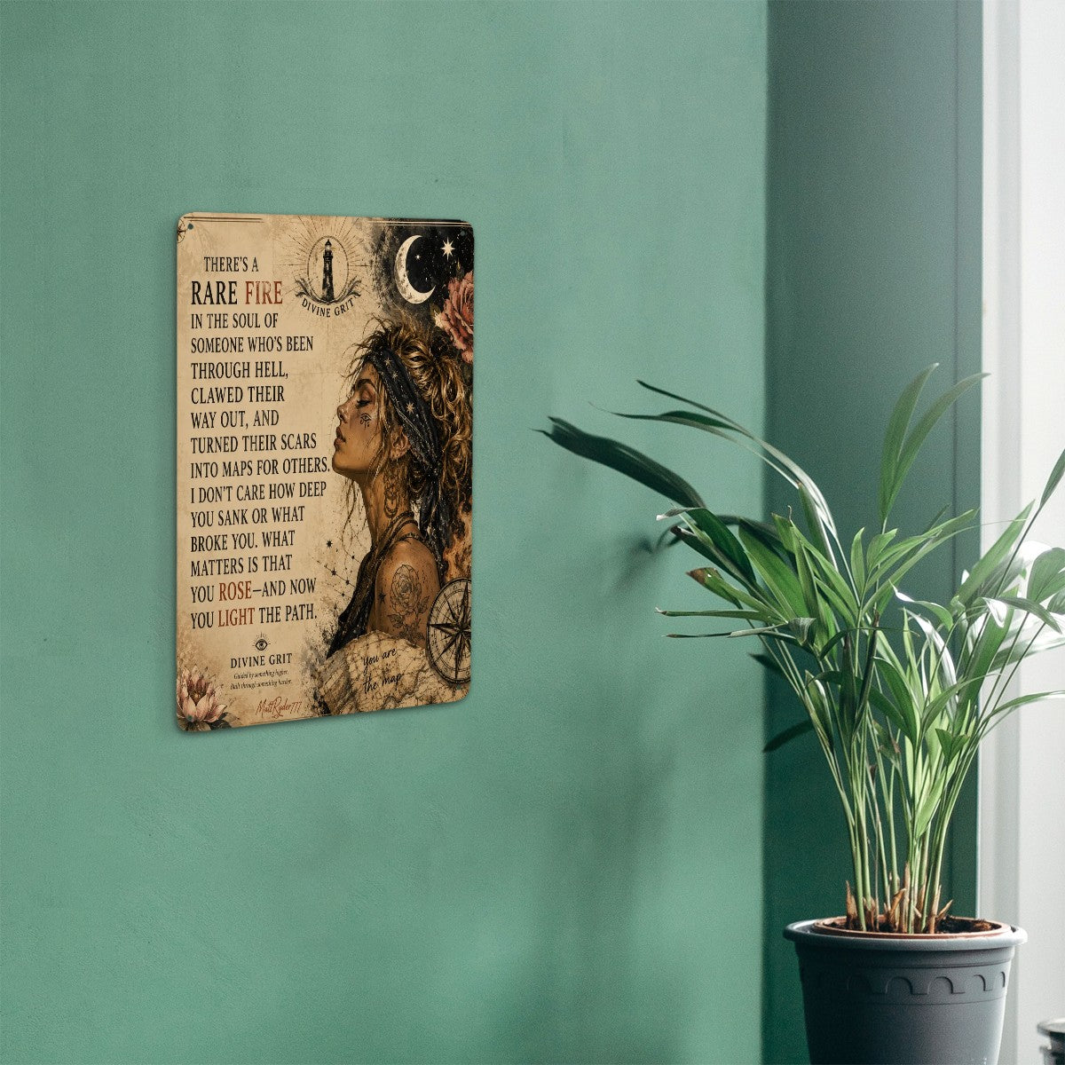 Inspirational quote wall art with celestial elements and a portrait of a woman on a green wall.
