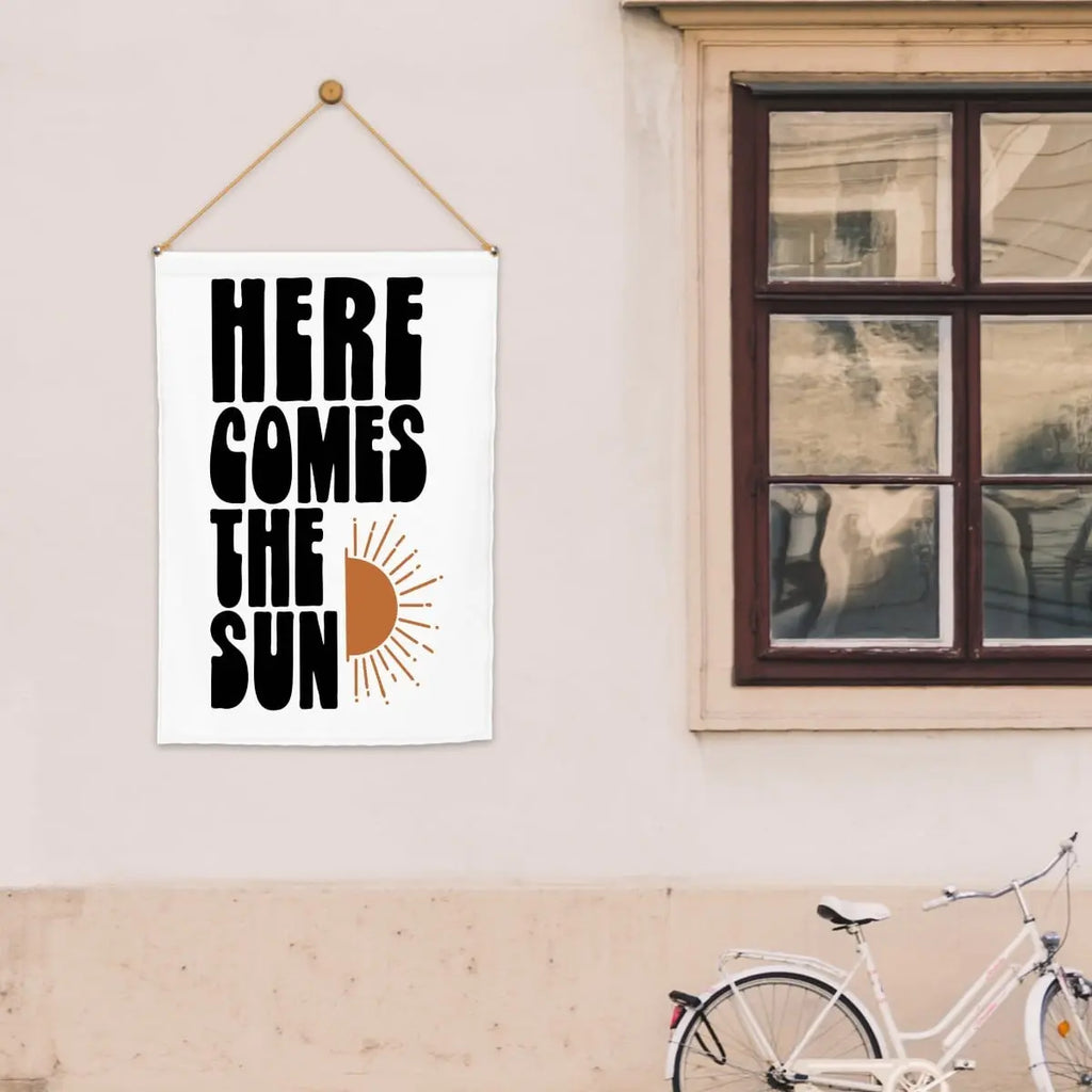 Colorful "Here Comes The Sun" garden flag by Sandy Beach, featuring bright sun and floral design for outdoor garden decor.
